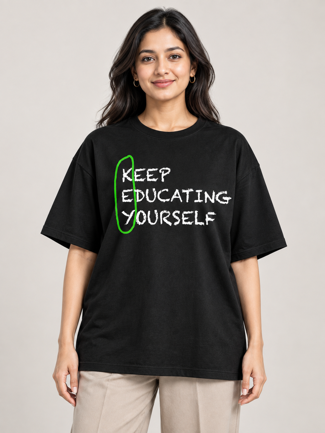 Female model wearing Keep Educating Yourself black oversized printed T-shirt in an office setting